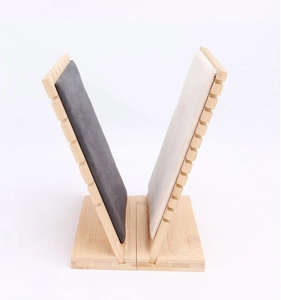 Macro detail of natural bamboo base and fabric necklace display stand with side grooves