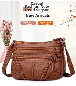 Detail of brown vintage soft leather crossbody bag with V-weave strap and multi-zipper pockets