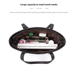 Internal view of black leather tote bag showing spacious compartments and storage capacity