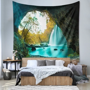 Detail of bohemian tapestry featuring a tropical waterfall landscape in a bedroom setting