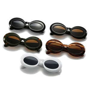Oval thick frame sunglasses in black, white, and tortoiseshell with vintage stripe details