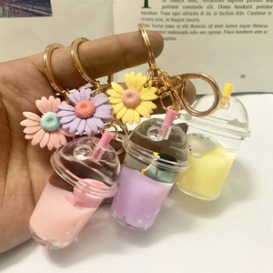 Detailed view of acrylic milk tea keychains with liquid quicksand and floating animals