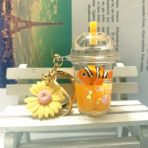 Detail of acrylic milk tea keychain with floating clownfish and sunflower charm
