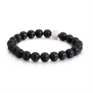 Minimalist beaded bracelet featuring matte black beads and a white marble stone accent