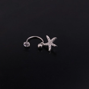 Detail of C-shaped steel piercing stud featuring a star charm and sparkling zircon stones