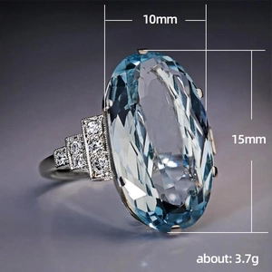 Anillo de plata con gran cristal azul ovalado y piedras laterales brillantes de 15x10mm