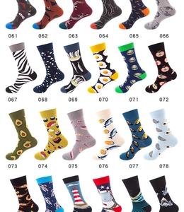 Flat lay of colorful mid-calf socks with various patterns from sushi to space themes