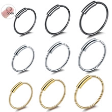Set of nine stainless steel nose and ear rings in black, gold, and silver finishes