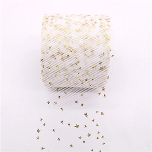 Detail of white tulle ribbon roll with sparkling gold star patterns for DIY crafts