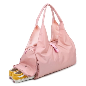 Pink waterproof travel duffel bag with a dedicated side shoe compartment for yoga