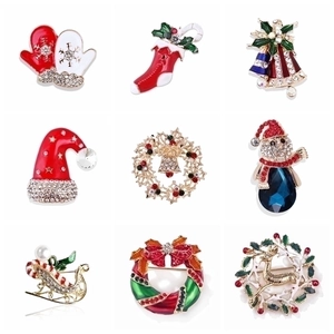 Set of 9 Christmas brooches featuring reindeer, bells, and trees with colorful enamel and crystals