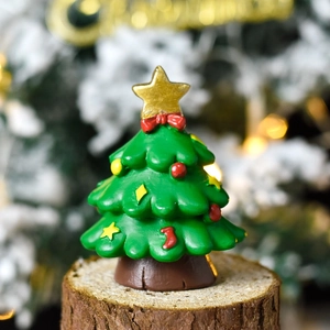 Miniature resin Christmas tree tabletop ornament with star topper and festive decorations