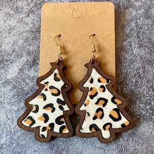 Close-up of Christmas tree leopard print wooden earrings on a kraft paper jewelry card