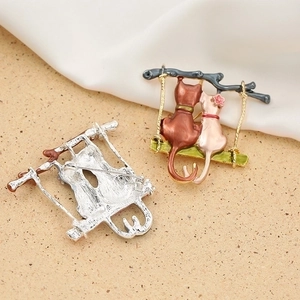 Charming enamel cat brooch with dual kittens on a swing and silver-tone metal back view