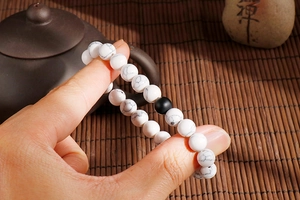 Close-up of 8mm white turquoise beaded bracelet with marble texture and zen aesthetic