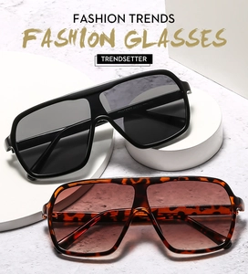 Detail view of large frame oversized sunglasses in black and tortoiseshell finishes