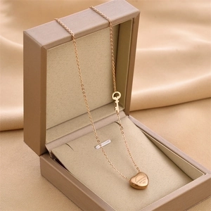 Rose gold heart and key pendant necklace displayed on silk inside a jewelry box