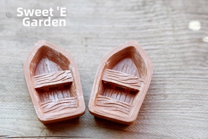 Macro shot of miniature resin boats with wood grain texture for micro landscape decor
