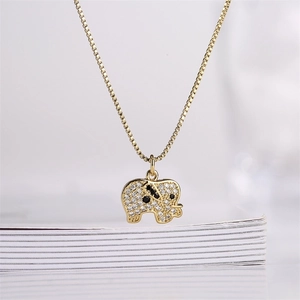 Macro shot of gold-plated elephant pendant with pavé zircons and detailed box chain