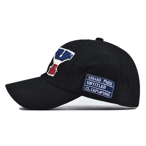 Close-up of vintage NY embroidery and side printed patch on black cotton baseball cap