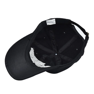 Detail view of cotton baseball cap interior showing stitching and 100% cotton label