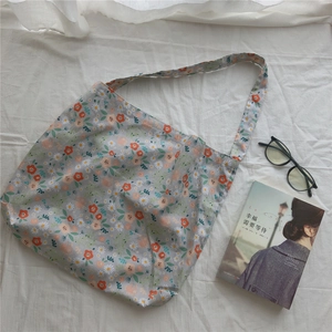 Detail view of floral cotton canvas tote bag with delicate print and soft textile texture