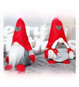 Close-up of Christmas gnomes ornaments with heart patches and braided hair detail