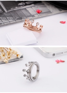 Detail of rose gold and silver crown rings with zircons and twisted rope patterns