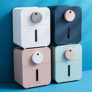 Close-up of tissue box organizers in white, navy, pink, and green on blue background