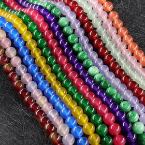 Detailed close-up of colorful round agate beads for DIY jewelry making accessories