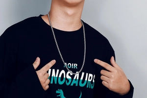Close-up of minimalist silver square pearl necklace worn by model on black t-shirt