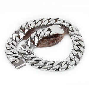 Rugged 31mm thick stainless steel Cuban link necklace for men on a stone background