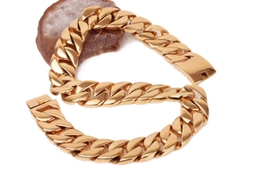Detail of heavy gold-plated stainless steel Cuban link chain with a secure box clasp