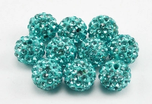 Macro shot of 10mm teal pave disco ball beads with micro rhinestones for DIY crafts