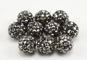 Detailed close-up of ten sparkling Shamballa beads in gun black clay and crystal rhinestones