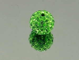 Macro view of a vibrant green 10mm rhinestone clay ball bead with mirror reflection