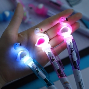 Three LED glowing flamingo ballpoint pens in blue, pink, and purple for students