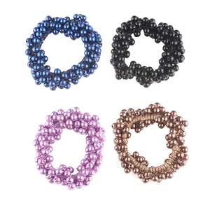 Elastic pearl hair ties in blue, black, purple, and bronze shown in a grid view