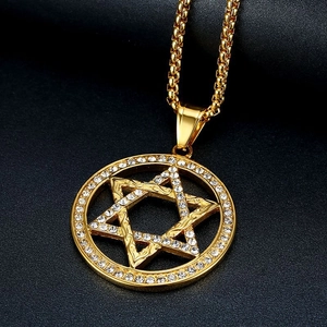 Iced out gold hexagram pendant necklace with sparkling crystals on black background