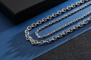 Close-up of polished stainless steel O-chains and cross chains in various thicknesses