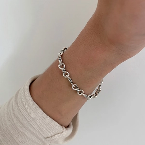 Detailed view of handcrafted 925 sterling silver twisted chain bracelet on wrist