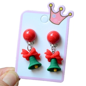 Christmas jingle bell earrings featuring red bows and green beads on white display card