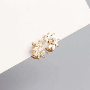 Detail of gold floral hoop earrings with marquise-cut zircons on a white display card