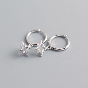 Detail of silver S925 sterling silver hoop earrings with pavé zircon star charms