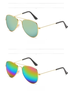 Close-up of golden aviator sunglasses with reflective rainbow and gold mercury lenses