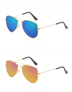 Detail view of gold aviator kids sunglasses with blue and pink reflective lenses