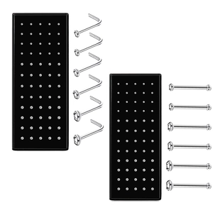 Detailed view of silver stainless steel L-shaped nose studs on professional black display pads