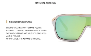 Detail view of large frame sunglasses featuring vibrant green mirrored lenses and sleek frame