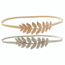 Detailed view of gold and silver elastic belts with intricate metal leaf buckles