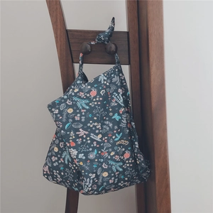Detailed view of dark blue floral cotton fabric with colorful botanical patterns